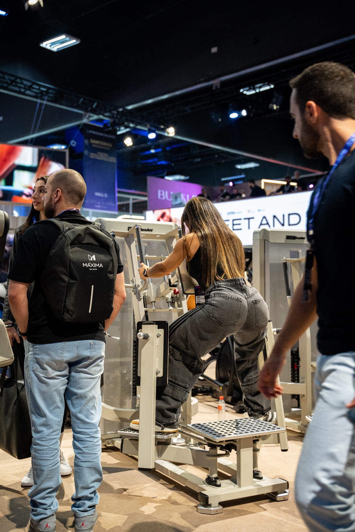 Athlete using the Gluteleader Standing Abductor GL-1005 at a fitness exhibition