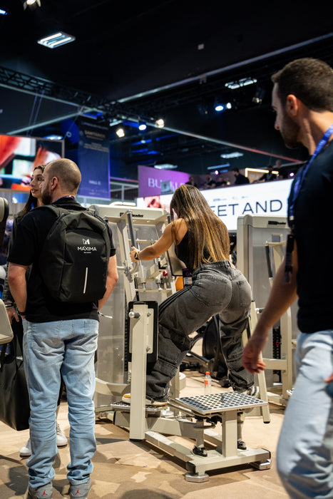 Athlete using the Gluteleader Standing Abductor GL-1005 at a fitness exhibition